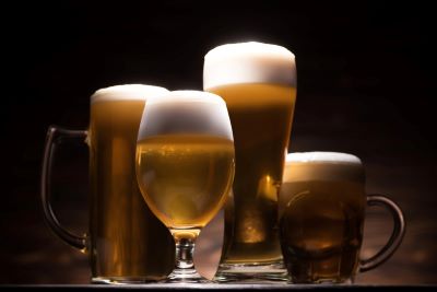 Glasses of beer on a wood table Glasses of beer on a wood table