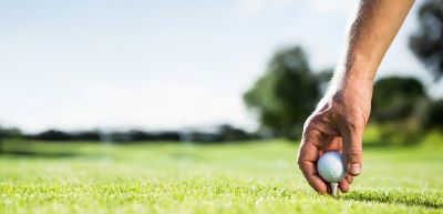 Golfer Placing Ball on Tee