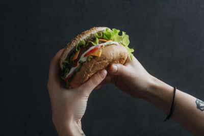 Hands holding a burger Hands holding a burger